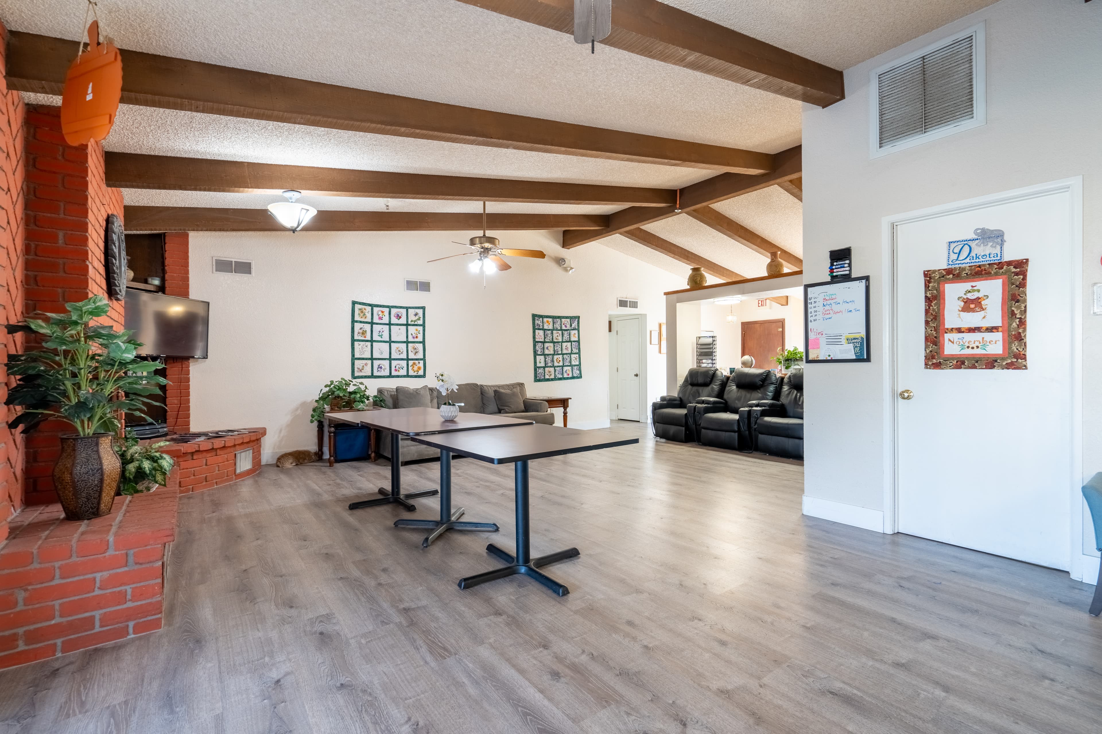 Spacious common room with tables and brick fireplace